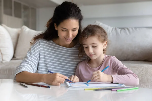 Happy Latino mom and small daughter drawing —  Fotos de Stock