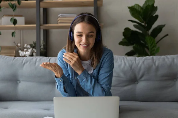 Woman in headphones looks at laptop screen participate in stream — Foto de Stock