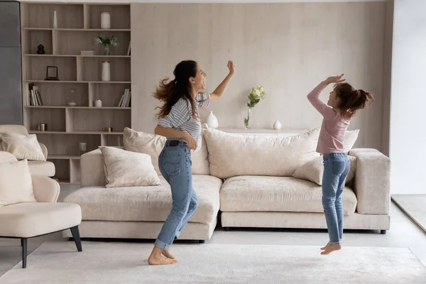 Happy Latino mom and small daughter dance at home — Photo