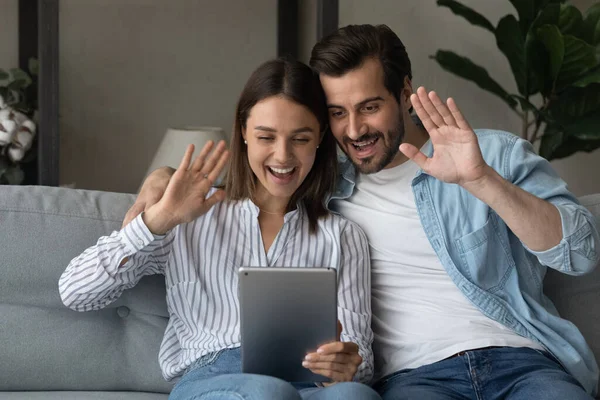 Couple sit on couch use tablet start talk via videoconference — Foto Stock