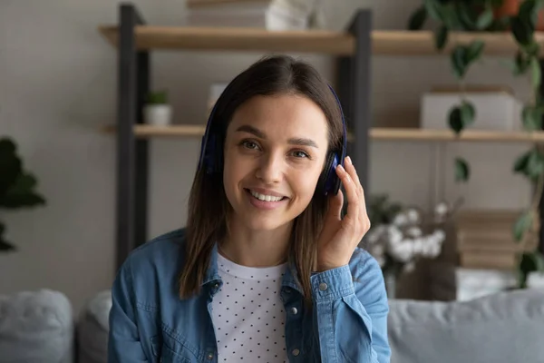 Profile picture attractive woman listens to friend through wireless headphones — Stock Photo, Image