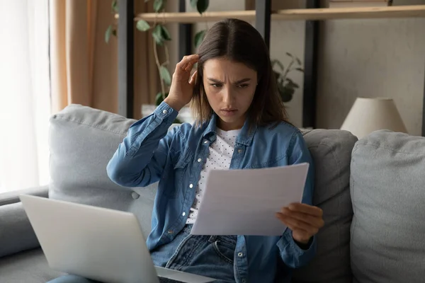 Gloomy young woman feels worried while read document — Stockfoto