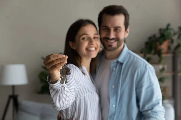 Happy married couple holding keys from new bought house, closeup — Stock fotografie