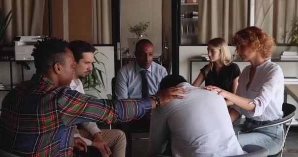 Diverse friendly people supporting unhappy man at group therapy session — Vídeo de Stock