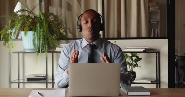 Middle aged African businessman use laptop negotiating by videocall — Stockvideo