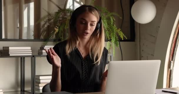 Female tutor wear headset use laptop app teaching learner remotely — Stockvideo