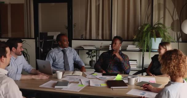 Group of multiracial businesspeople negotiating sit at table in boardroom — Vídeo de Stock