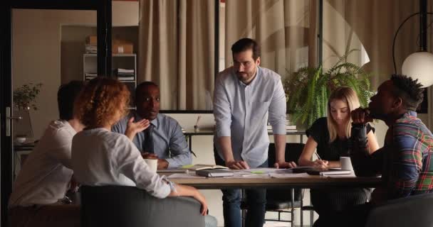 Multiracial teammates brainstorming during morning briefing in modern office boardroom — Stockvideo