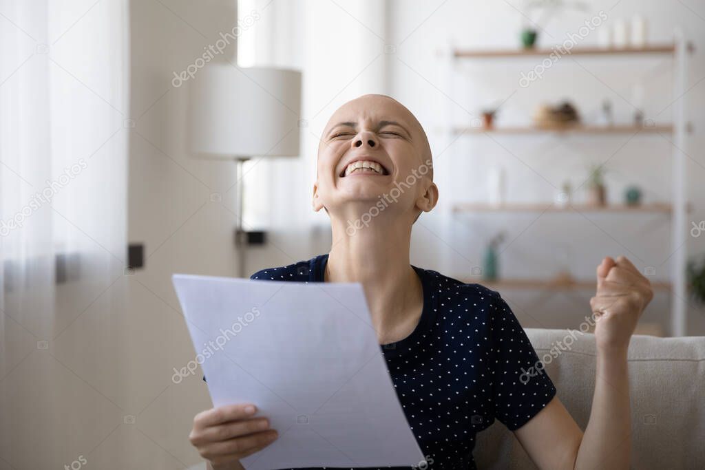 Overjoyed young bald woman getting letter with amazing news.