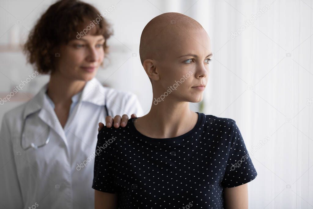 Young female oncologist supporting stressed cancer patient.