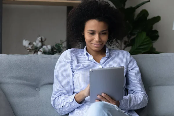 Happy African American woman have video call on pad