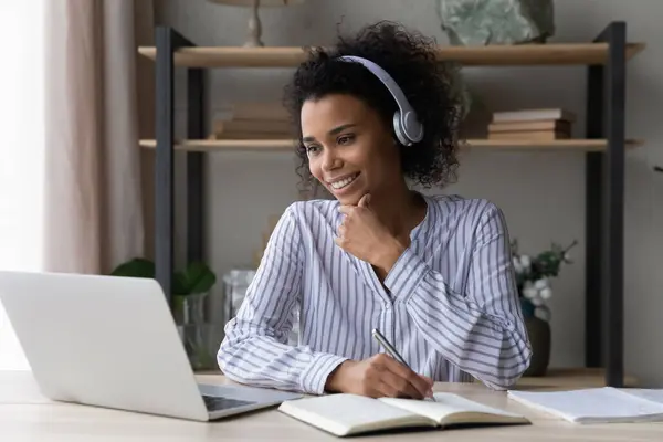 Smiling ethnic female study online on laptop — Stock Photo, Image