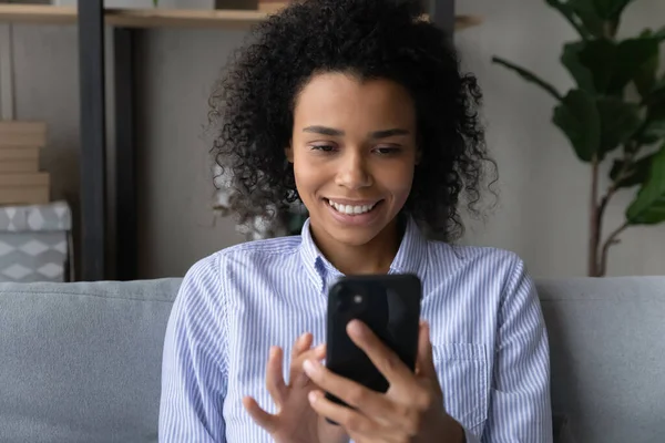 Smiling African American woman talk on video call on cell