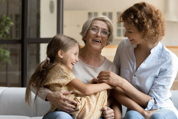 Happy little girl with mother and mature grandmother having fun — Stock Photo, Image