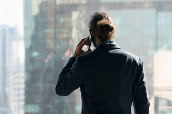 Joven empresario africano serio conversando por teléfono. — Foto de Stock