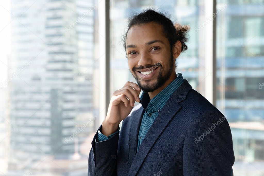 Portrait of confident smiling young african american business man.