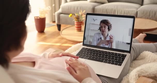 Молодая беременная женщина проводит видеозвонок с гинекологом. — стоковое видео