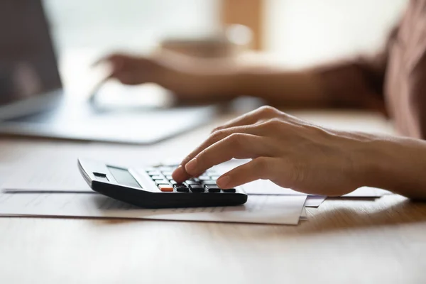 Close up of woman calculate expenses on machine — Stock Photo, Image