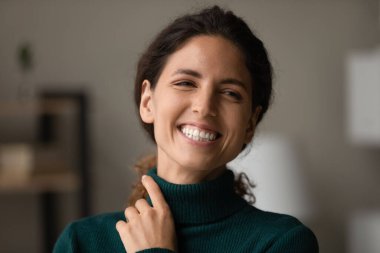 Kafasından vurulmuş, neşeli, hayalperest kadın gülüyor, bir kenara bakıyor.