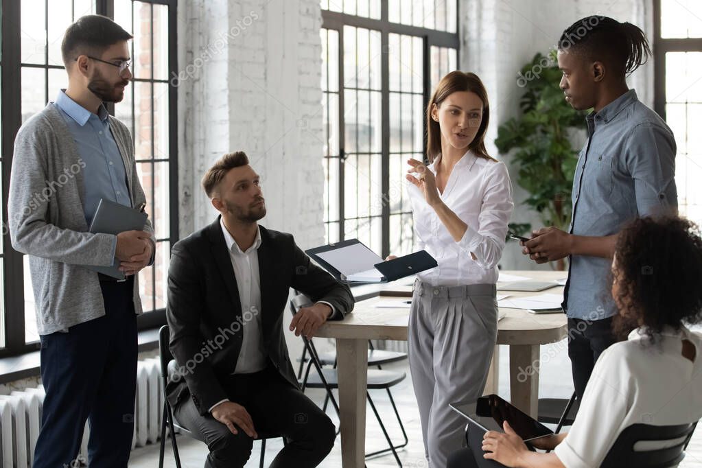 Young diverse businesspeople engaged in team thinking in office