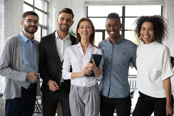 Portrait of smiling diverse businesspeople pose in office — Stock Photo, Image