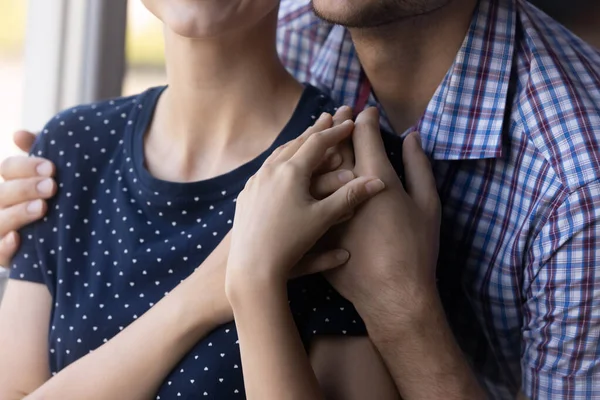 Close up shot of young couple hugging at window — Stock Photo, Image