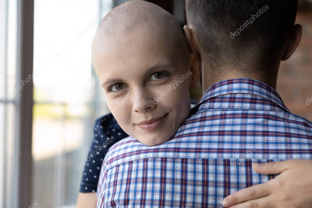 Happy millennial girl with cancer embracing boyfriend