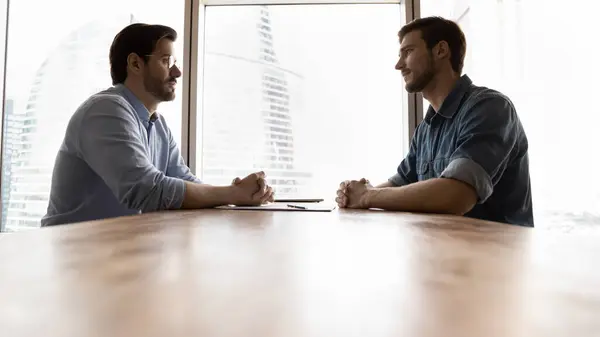 stock image Two businessmen, business competitors, opponents sitting opposite