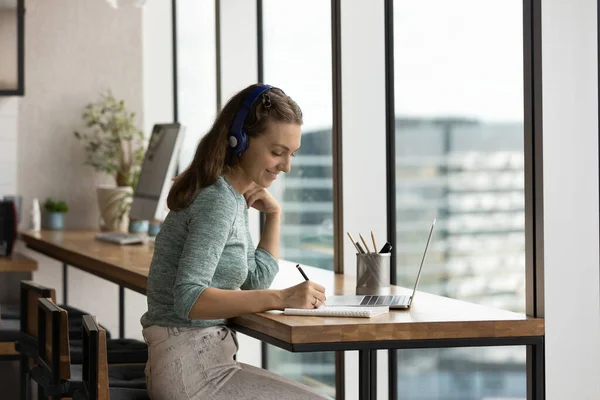 Happy gen Z student girl in headphones studying online — Stock Photo, Image