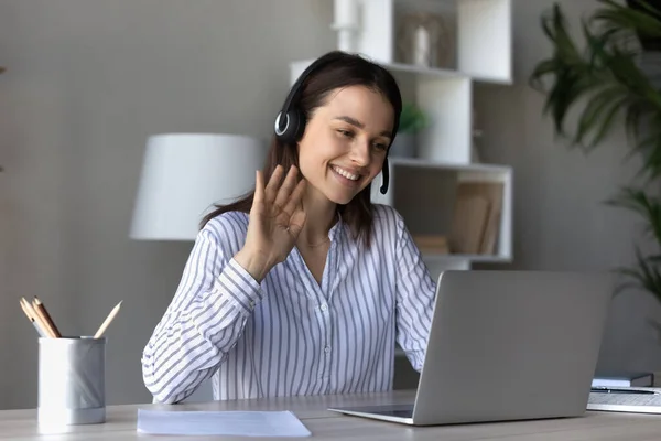 Smiling young woman wave talking on video call on laptop — Stock Photo, Image