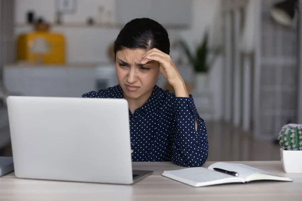 Unhappy Indian woman feel bored working on laptop — 图库照片