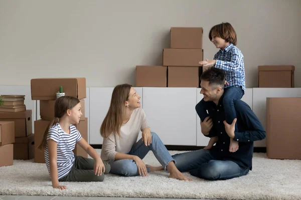 Family with kids resting sit on floor on relocation day — Foto de Stock