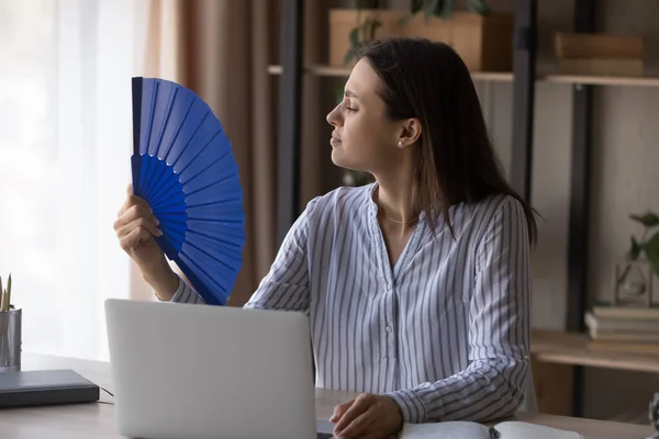 Unwell woman work at computer wave with hand fan — Stock fotografie