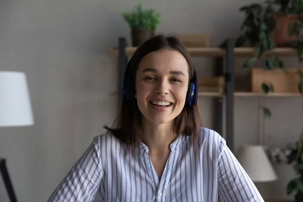 Portrait of smiling young woman in headphones have webcam call — Photo