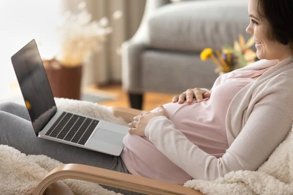 Happy late pregnant girl using laptop, using virtual telemedicine app — Stok fotoğraf