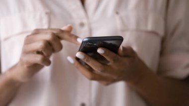 Close up of biracial woman use cellphone browsing internet