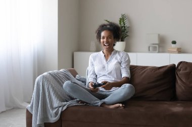 Overjoyed African American female play video game