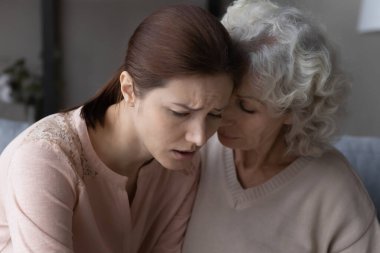 Loving old mother support unhappy adult daughter