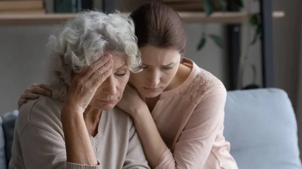 Loving adult daughter comfort support unhappy old mom — Stockfoto