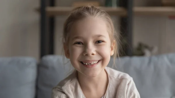 Portrait of smiling little girl talk on webcam call — Stock fotografie