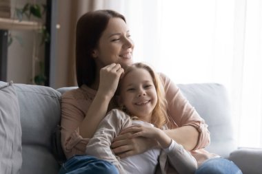 Portrait of loving mom and teen daughter relaxing