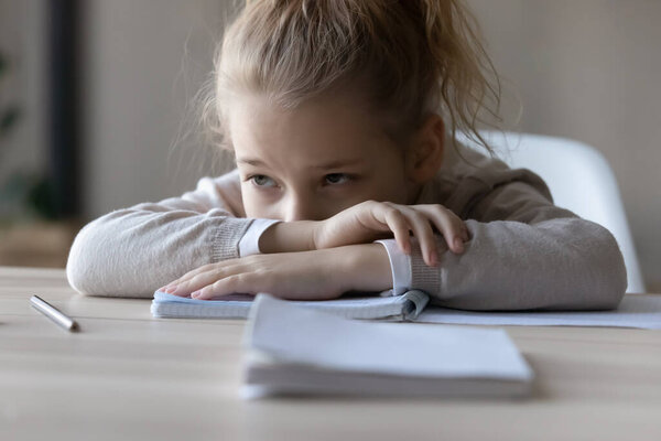 Unhappy small girl feel lazy studying at home