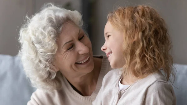 Happy grandmother and small granddaughter relax together — Stok fotoğraf