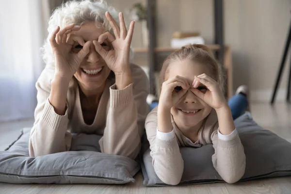 Portrait of smiling granny and grandchild play together — Stock Photo, Image
