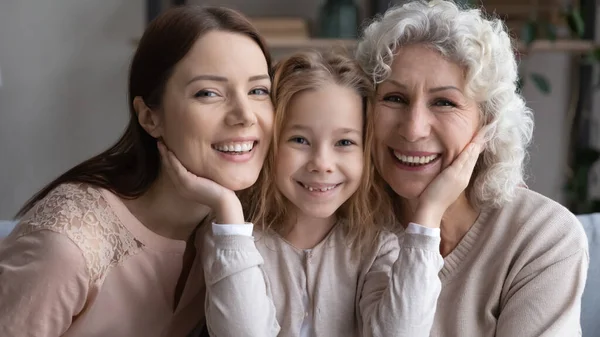 Portrait of happy three generations of women hug — Stock Photo, Image