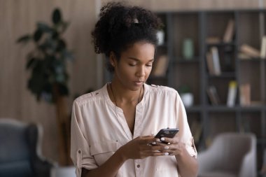African American woman use smartphone texting online