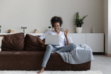 Smiling biracial woman in headset have webcam call