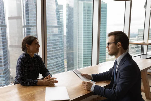 Multi ethnic young businesspeople negotiating in modern office — Stock Photo, Image