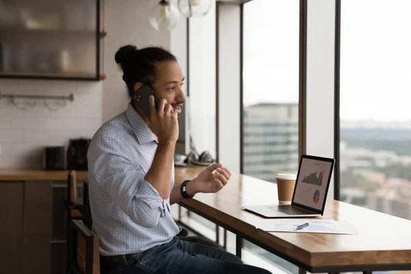 African businessman talks to client on phone analyzing sales growth — Foto Stock