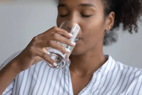 Close up of thirsty biracial woman drink water — Photo